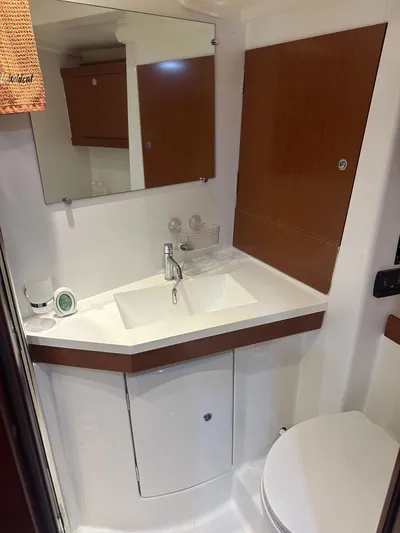  Yacht Photos Pics Beneteau Oceanis 50 bathroom, 2014 model, featuring a modern sink and mirror setup.