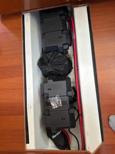  Yacht Photos Pics Battery compartment of a 2014 Beneteau Oceanis 50 sailboat with red cables.