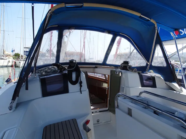 Sea Sea Rider Yacht Photos Pics 2017 Jeanneau Sun Odyssey 389 cockpit with blue canopy and marina view.