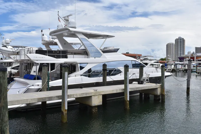  Yacht Photos Pics 2018 Azimut Flybridge yacht docked at marina with city skyline in background.