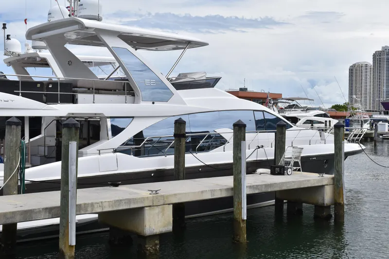  Yacht Photos Pics 2018 Azimut Flybridge yacht docked at a marina with cityscape background.