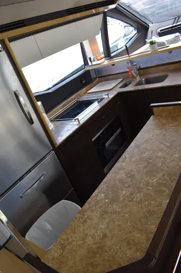  Yacht Photos Pics 2018 Azimut Flybridge yacht kitchen with modern appliances and sleek countertops.