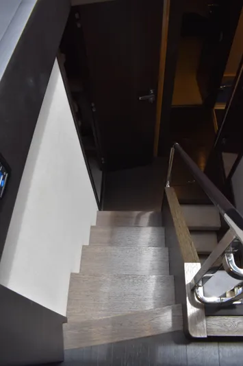  Yacht Photos Pics Staircase inside 2018 Azimut Flybridge yacht, featuring sleek wooden steps and modern design.