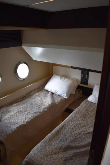  Yacht Photos Pics 2018 Azimut Flybridge cabin with twin beds and porthole window.