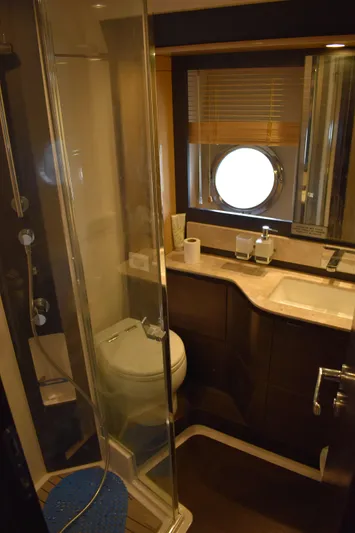 Yacht Photos Pics Luxurious bathroom in 2018 Azimut Flybridge yacht with modern fixtures and porthole window.