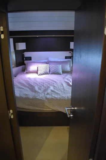  Yacht Photos Pics 2018 Azimut Flybridge yacht bedroom with cozy bedding and modern decor.