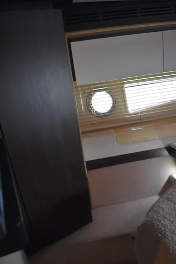  Yacht Photos Pics Interior of 2018 Azimut Flybridge yacht with porthole and modern furnishings.