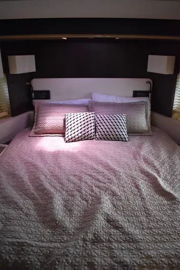  Yacht Photos Pics Luxurious bedroom interior of 2018 Azimut Flybridge yacht with elegant bedding.