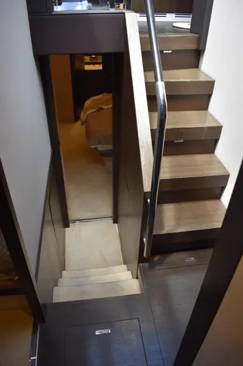  Yacht Photos Pics Staircase inside 2018 Azimut Flybridge yacht, featuring modern wood design and sleek handrail.