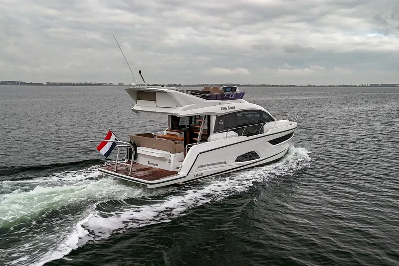  Yacht Photos Pics 2021 Sealine F430 yacht cruising on open water under cloudy skies.