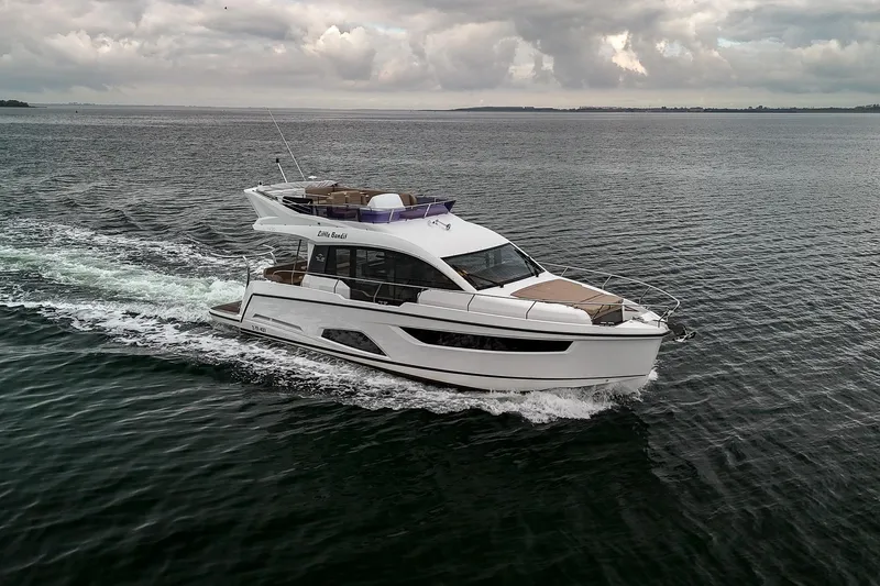  Yacht Photos Pics 2021 Sealine F430 yacht cruising on open water under cloudy skies.