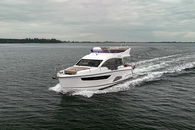  Yacht Photos Pics 2021 Sealine F430 yacht cruising on open water under cloudy skies.