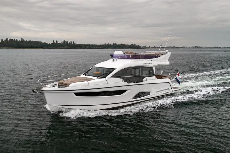  Yacht Photos Pics 2021 Sealine F430 yacht cruising on open water under cloudy skies.