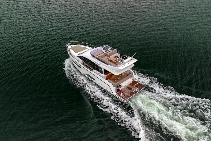  Yacht Photos Pics 2021 Sealine F430 yacht cruising on open water, aerial view.