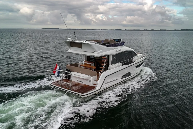  Yacht Photos Pics 2021 Sealine F430 yacht cruising on open water under cloudy skies.