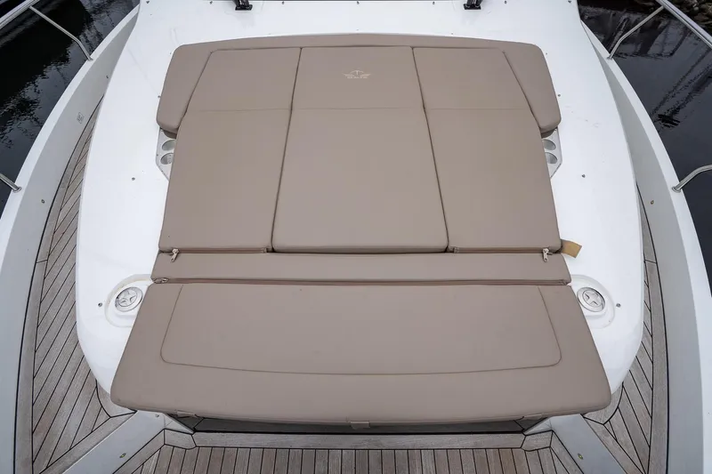  Yacht Photos Pics 2021 Sealine F430 yacht with beige sunbed on deck, surrounded by wooden flooring.