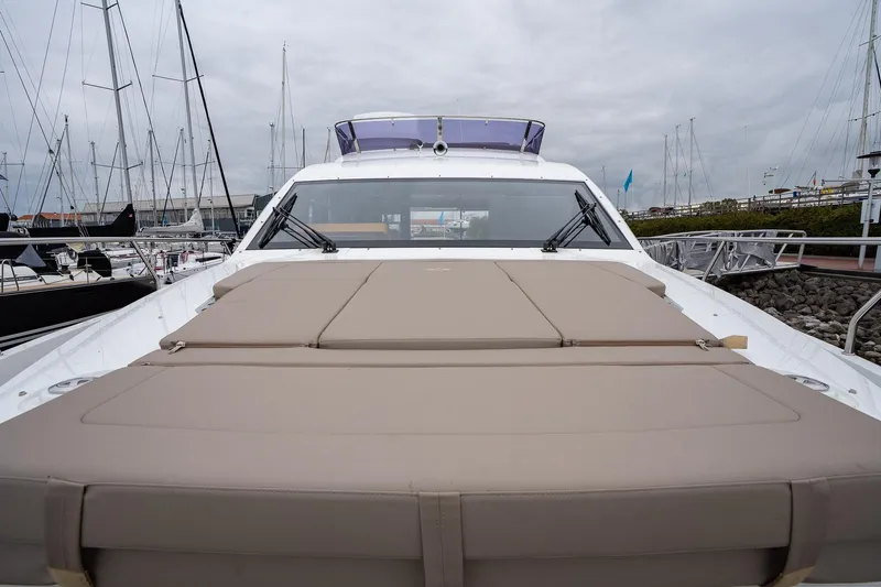 Yacht Photos Pics 2021 Sealine F430 yacht with spacious deck, docked at marina under cloudy sky.