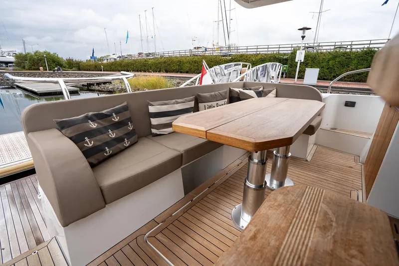  Yacht Photos Pics Luxurious 2021 Sealine F430 yacht deck with elegant seating and wooden table.