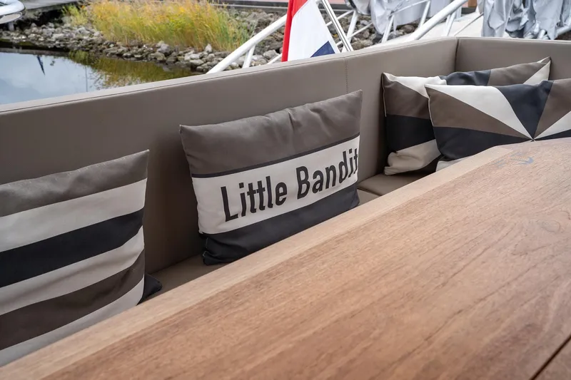  Yacht Photos Pics Sealine F430 2021 yacht interior with decorative cushions and wooden table.