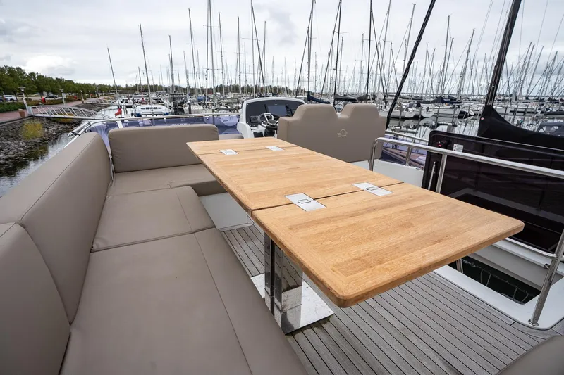  Yacht Photos Pics Luxurious 2021 Sealine F430 yacht with spacious outdoor seating and wooden table.