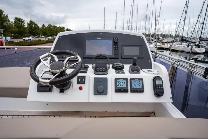  Yacht Photos Pics Control panel of 2021 Sealine F430 yacht with navigation instruments and steering wheel.