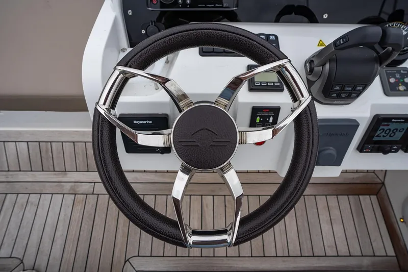  Yacht Photos Pics Steering wheel of 2021 Sealine F430 yacht, featuring modern controls and sleek design.