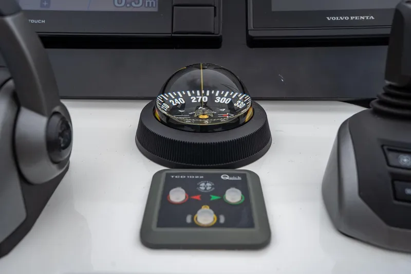  Yacht Photos Pics Control panel of a 2021 Sealine F430 yacht featuring a compass and navigation controls.