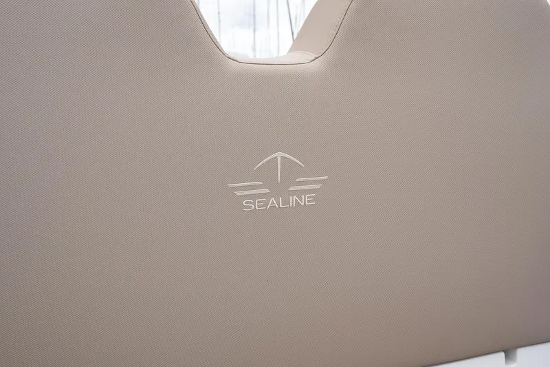  Yacht Photos Pics Sealine F430 2021 boat seat with embossed logo on beige upholstery.
