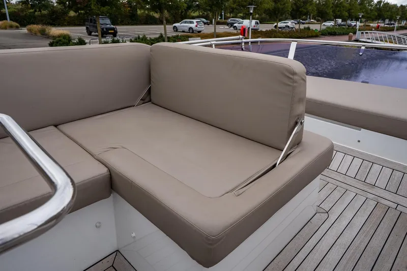  Yacht Photos Pics Luxurious seating on 2021 Sealine F430 yacht with beige cushions and wooden deck.