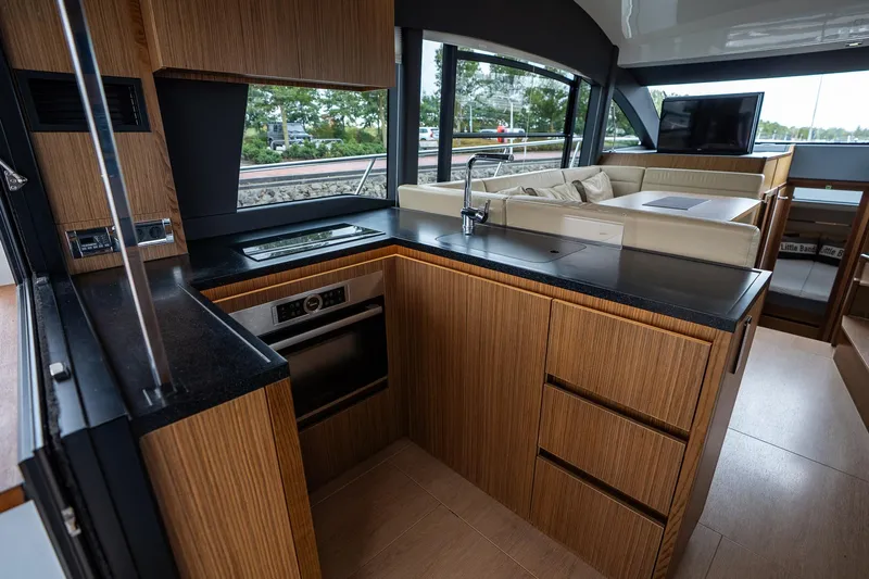  Yacht Photos Pics Luxurious interior of 2021 Sealine F430 yacht with modern kitchen and seating area.