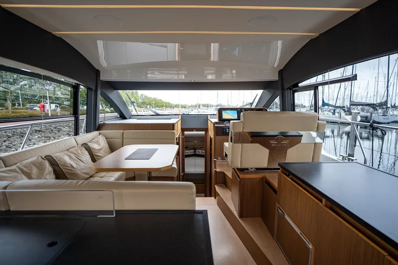  Yacht Photos Pics Luxurious interior of 2021 Sealine F430 yacht with elegant seating and modern navigation.