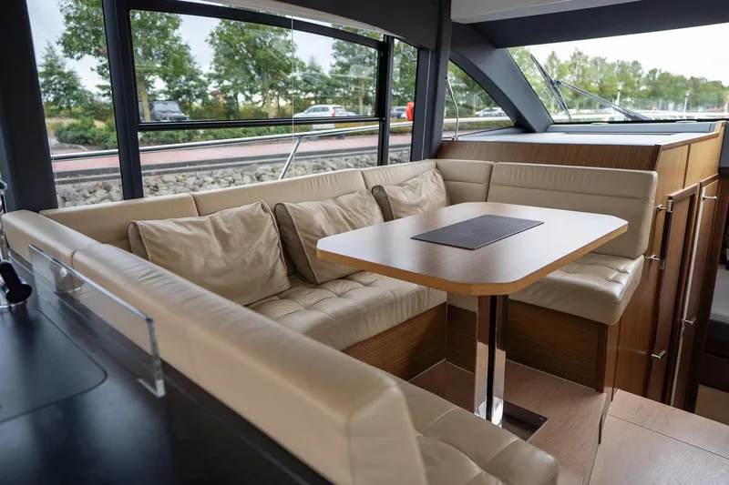  Yacht Photos Pics Luxurious interior of 2021 Sealine F430 yacht with plush seating and elegant table.