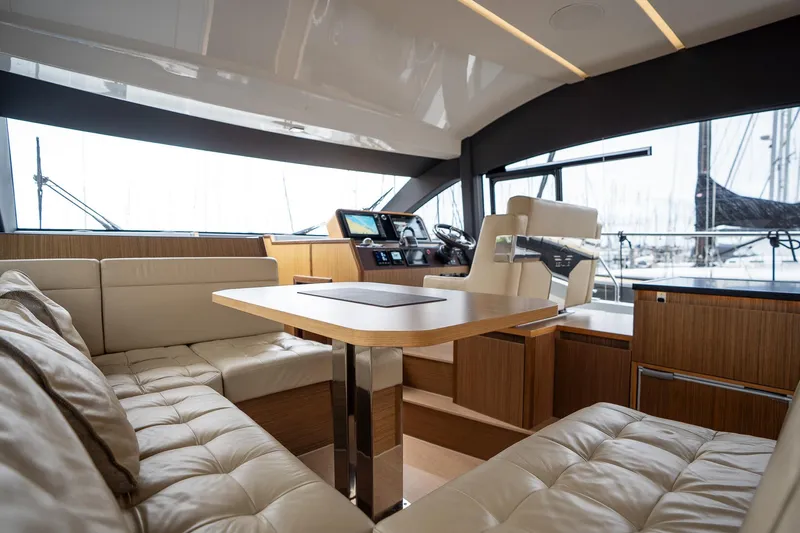 Yacht Photos Pics Luxurious interior of 2021 Sealine F430 yacht with modern seating and helm station.