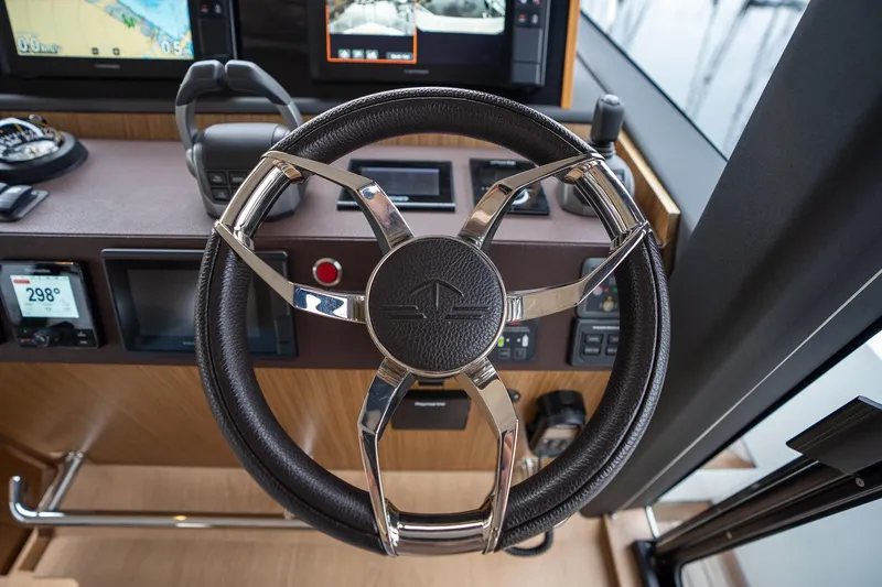  Yacht Photos Pics Steering wheel of 2021 Sealine F430 yacht with modern dashboard controls.