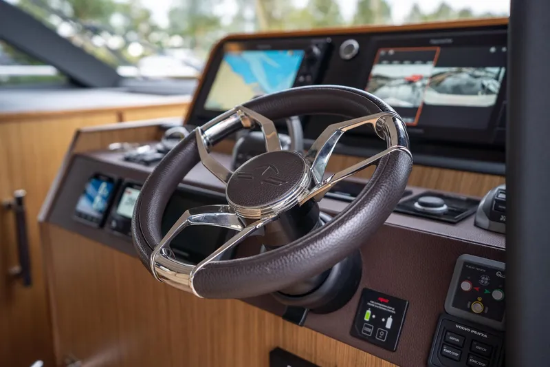  Yacht Photos Pics Steering wheel and dashboard of 2021 Sealine F430 yacht, featuring modern navigation displays.
