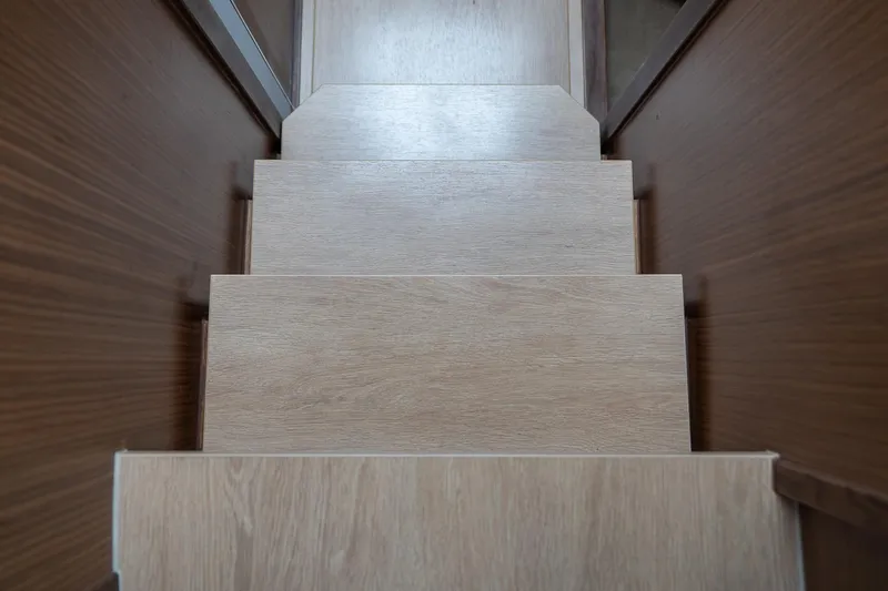  Yacht Photos Pics Wooden stairs inside 2021 Sealine F430 yacht, showcasing sleek interior design.