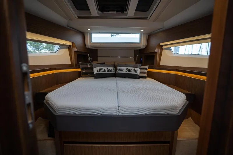  Yacht Photos Pics Luxurious cabin interior of 2021 Sealine F430 yacht with cozy bedding and ambient lighting.