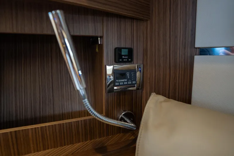  Yacht Photos Pics Interior detail of 2021 Sealine F430 yacht, featuring modern control panel and sleek wood finish.