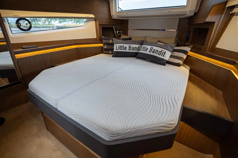  Yacht Photos Pics Luxurious cabin interior of 2021 Sealine F430 yacht with modern bedding and wood accents.