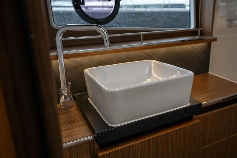  Yacht Photos Pics Luxury bathroom sink in 2021 Sealine F430 yacht, featuring modern design and elegant wood finish.