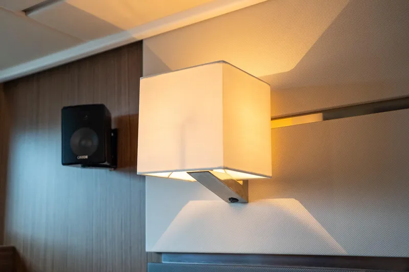  Yacht Photos Pics Wall-mounted light fixture and speaker inside 2021 Sealine F430 yacht interior.
