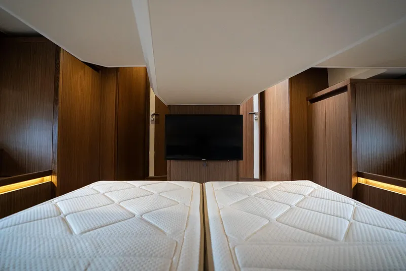  Yacht Photos Pics Luxurious interior of 2021 Sealine F430 yacht with twin beds and TV.