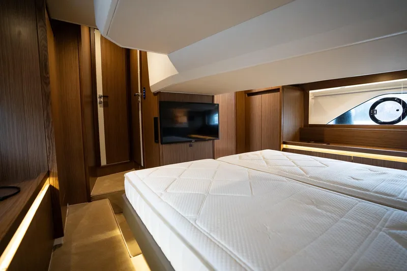  Yacht Photos Pics Luxurious interior of 2021 Sealine F430 yacht with modern bedroom and TV.