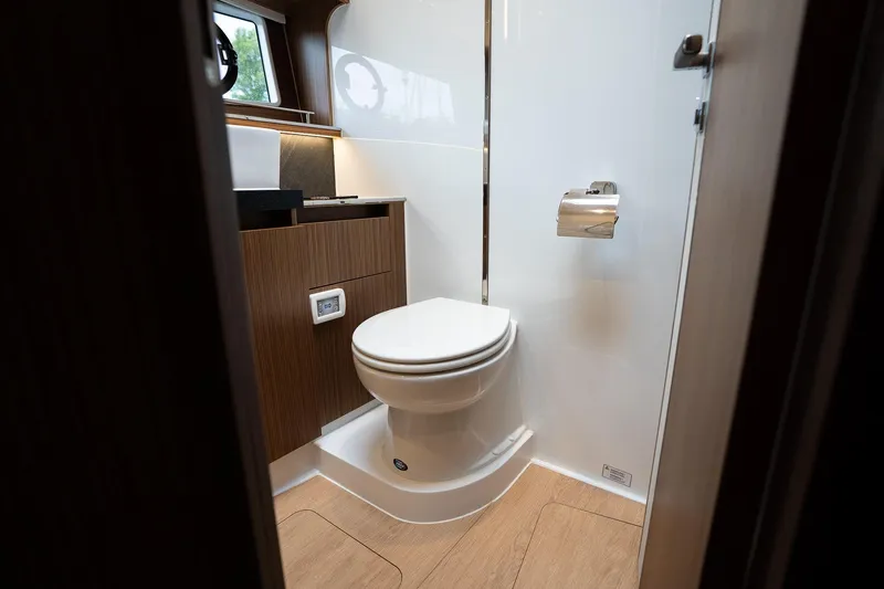  Yacht Photos Pics Luxury bathroom interior of 2021 Sealine F430 yacht, featuring modern fixtures and wood accents.