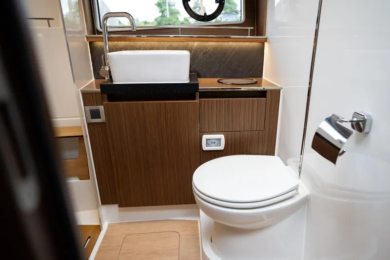  Yacht Photos Pics Luxurious bathroom in 2021 Sealine F430 yacht with modern fixtures and wood accents.