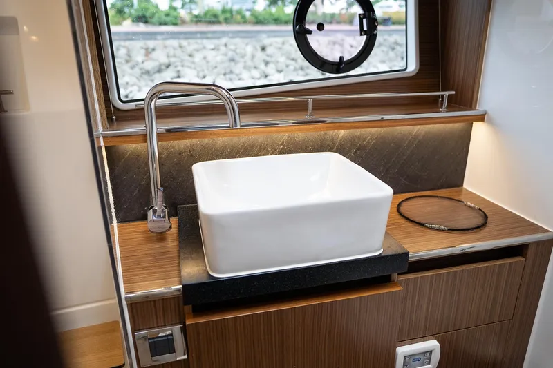  Yacht Photos Pics Modern bathroom sink in 2021 Sealine F430 yacht, featuring sleek design and wood accents.