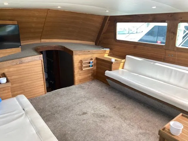 Waverunner Yacht Photos Pics Luxurious interior of 2022 Custom Carolina Sportfish with wood paneling and white seating.