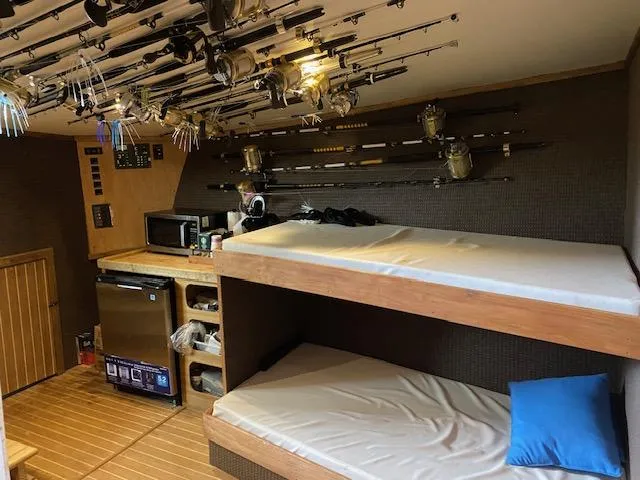 Waverunner Yacht Photos Pics Interior of 2022 Custom Carolina Sportfish with bunk beds and fishing gear.