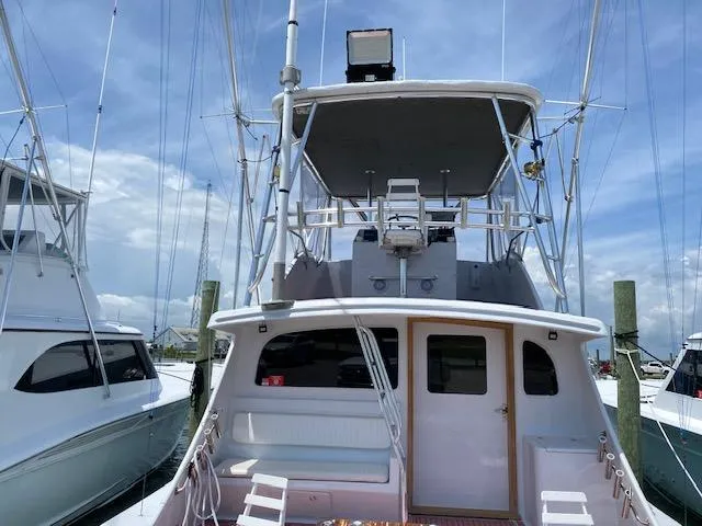 Waverunner Yacht Photos Pics 2022 Custom Carolina Sportfish boat docked at marina, rear view.