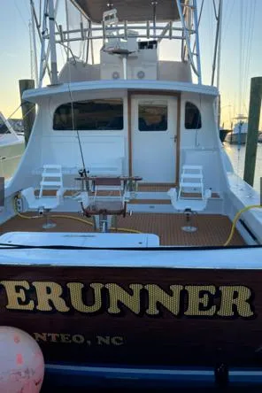Waverunner Yacht Photos Pics 2022 Custom Carolina Sportfish boat docked, rear view with fishing chairs and equipment.